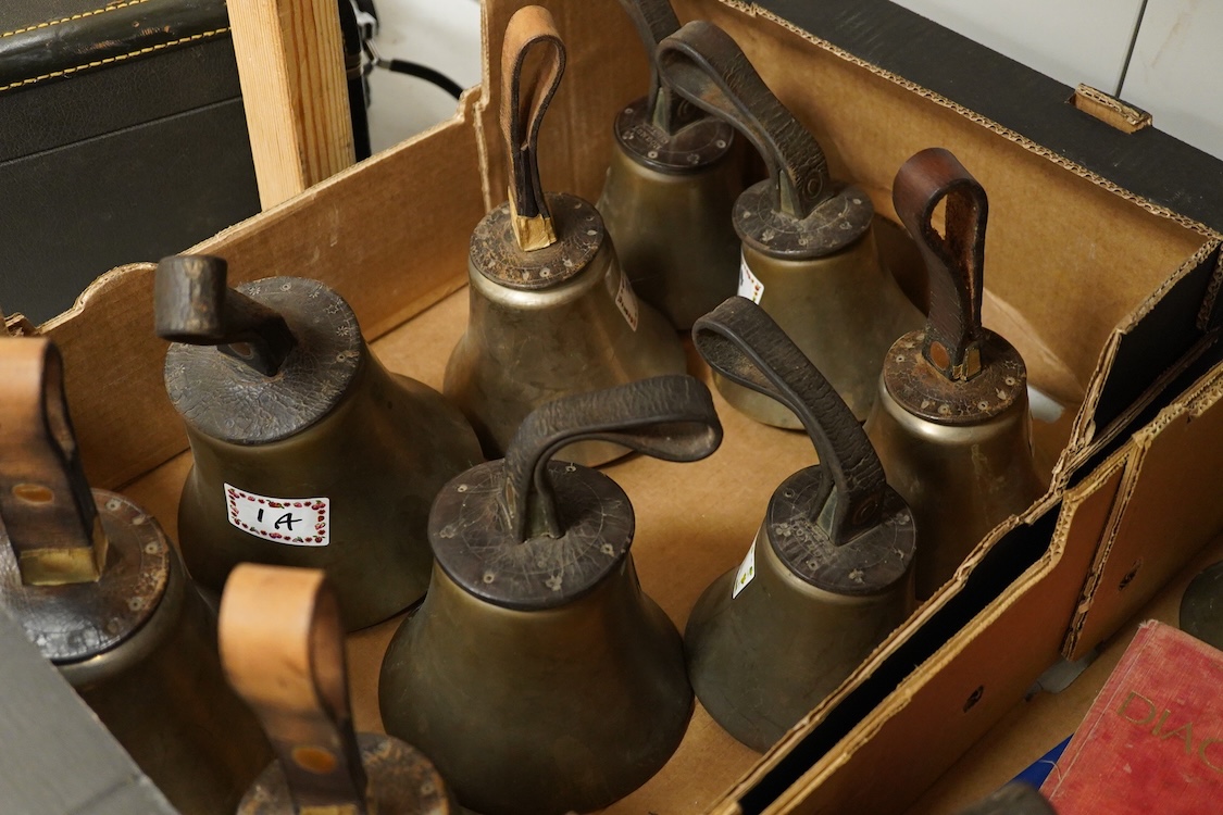 A set of twenty-two bronze handbells by Mears, London, with leather grips, together with two books from the Jasper Snowden Change Ringing Series, largest diameter 16cm
